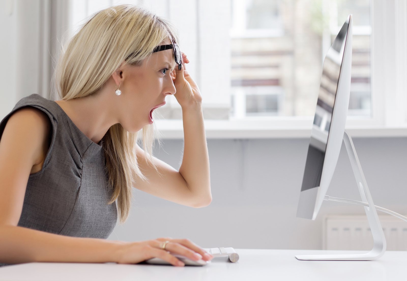 bigstock-Shocked-woman-looking-at-compu-79387936